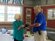 Chief George Brothers accepting gift from Mayor Jane Darby